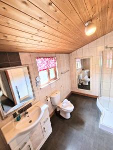 a bathroom with a sink and a toilet and a tub at Lomond 2 with Private Hot Tub - Fife - Loch Leven - Lomond Hills in Kelty