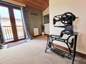 an old fashioned sewing machine in a room with a window at Lomond 2 with Private Hot Tub - Fife - Loch Leven - Lomond Hills in Kelty