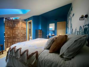 1 dormitorio con 1 cama grande y paredes azules en Dúplex en el corazón de Haro, en Haro