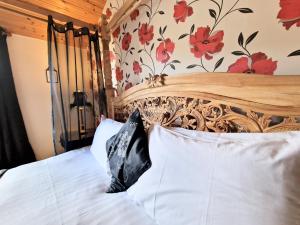a bedroom with a bed with a wooden headboard at Lomond 4 with Private Hot Tub - Fife - Loch Leven - Lomond Hills in Kelty