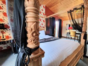 a bedroom with a large bed with a wooden ceiling at Lomond 4 with Private Hot Tub - Fife - Loch Leven - Lomond Hills in Kelty