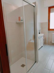 a glass shower in a bathroom with a sink at Casa ANNA in Montevarchi +28 photos