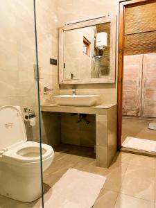 bagno con servizi igienici e lavandino di Eco Bliss Cottages - Thanamalwila 
