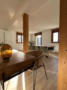 a living room with a wooden table and chairs at Le Balcon de Bramont in La Bresse