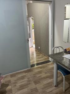 a dining room with a table and a door to a hallway at Ribas Pousada e Camping in Carambeí