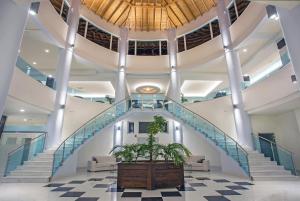 a staircase in a building with a potted plant at Grand Blue Beach Hotel in Kardamaina