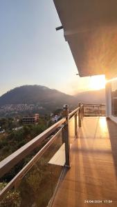 a balcony with a view of a mountain at Host Labs Homestay - Premium View - Close to Kaichi Dham, Bhimtal, Sattal, and more in Bhīm Tāl