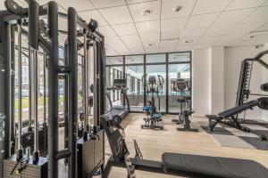 a gym with treadmills and cardio equipment in a building at Nadmorski Loft GREEN PORT SPA in Kołobrzeg