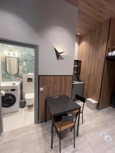 a bathroom with a table and a toilet and a sink at Tilzes Studio apartaments, Self check-in, Free parking, Comfort in Klaipėda