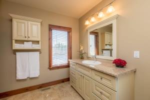 a bathroom with a sink and a mirror at Endless Summers Fabulous Lake oasis in Port Severn