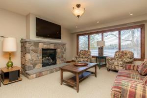 a living room with a couch and a fireplace at Endless Summers Fabulous Lake oasis in Port Severn