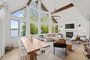a large living room with a table and chairs at Muskokan Mirage Located on Mirage Lake in Novar