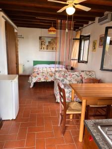 a living room with a bed and a table at Poggio Baroni Agriturismo in Manciano