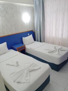 Postel nebo postele na pokoji v ubytování Dilhan Hotel
