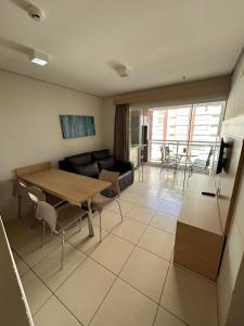 a living room with a table and a couch at Caldas Novas - Condominio Casa da Madeira - ate 5 pessoas - PERMITIDO descer com bebida para o parque - Centro in Assis