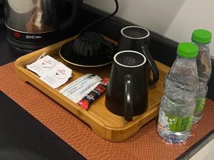 a tray with two coffee makers and water bottles at Boulevard Jar استديو مميز بالبوليفارد 203 in Riyadh