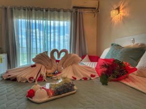 two swans dressed in dresses on a bed at Hotel Aconchego do Velho Chico in Piranhas