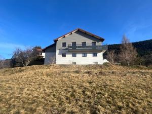 a white house on top of a hill at Le Balcon de Bramont in La Bresse