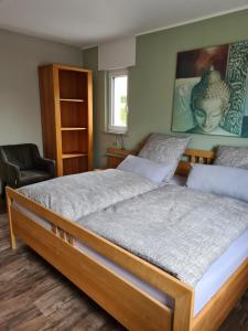 a bedroom with two beds and a chair at Ferienwohnung Burgblick in Pelm