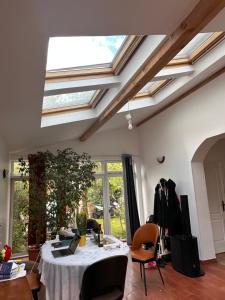 a living room with a table and a skylight at Maison avec Jardin proche Porte Maillot in Colombes +15 photos