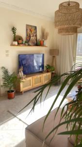a living room with a flat screen tv on a entertainment center at Gardinia city compound, Nasr city in Cairo