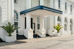 a white building with a gazebo in front of it at Hotel Atlantic Hamburg, Autograph Collection in Hamburg