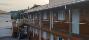 a building with windows and a bike parked next to it at Residencial Via Mar - Massaguaçu in Caraguatatuba