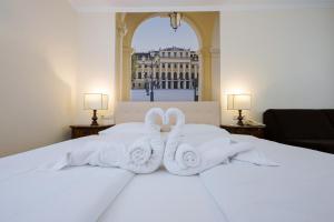 a hotel room with towels on a bed with a window at Hotel Royal in Vienna