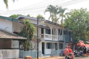 a group of people sitting in front of a building at Fortunate angle guesthouse 乐居 in Luang Prabang