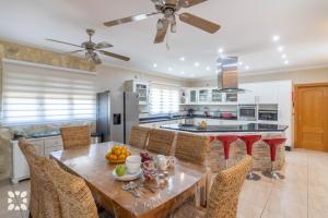 a kitchen with a table and chairs and a kitchen with a counter at Villa Airlie by Abahana Villas in Calpe