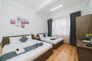 Postel nebo postele na pokoji v ubytování AN TÂM House Đà Lạt