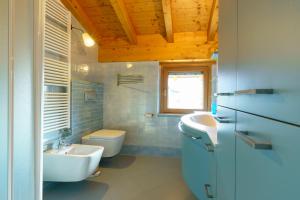 a bathroom with a sink and a toilet at Villetta Maurizia in Domaso +15 photos