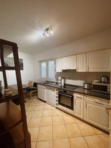 a kitchen with white cabinets and a stove top oven at Apartments im Herzen Lübecks in Lübeck