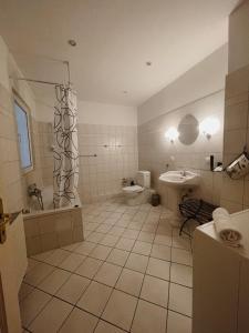a bathroom with a sink and a toilet and a shower at Apartments im Herzen Lübecks in Lübeck
