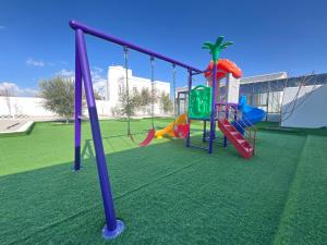 a playground with a slide in a park at ALSALAM HOSTELS in Nizwa