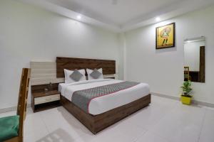 a bedroom with a large bed in a room at Townhouse Hotel Rooftop in Rishīkesh
