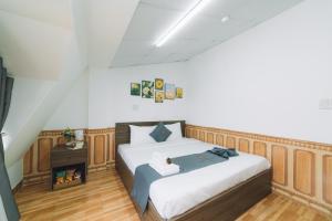 um quarto com uma cama grande e painéis de madeira em AN TÂM House Đà Lạt em Da Lat