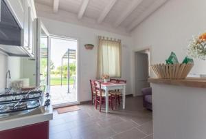 a kitchen with a table and a dining room at Agriturismo Le Terre in Mesagne