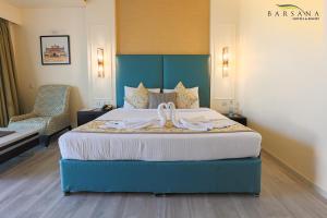 a hotel room with a bed with a bow on it at Barsana Hotel & Resort Siliguri in Siliguri