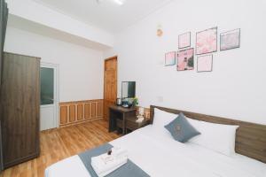 Postel nebo postele na pokoji v ubytování AN TÂM House Đà Lạt
