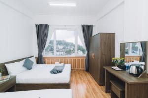 Postel nebo postele na pokoji v ubytování AN TÂM House Đà Lạt