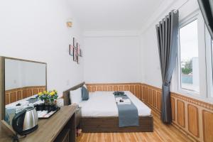 Postel nebo postele na pokoji v ubytování AN TÂM House Đà Lạt