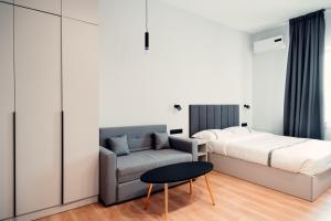 a bedroom with a bed and a couch and a table at Green Hill Hotel in Almaty +29 photos