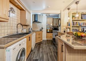 a kitchen with a washer and dryer in it at Harbour Lodge - Teignmouth in Teignmouth