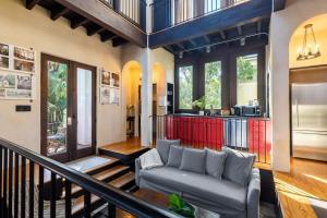 a living room with a couch and a kitchen at European Influences in the Heart of Charleston in Charleston