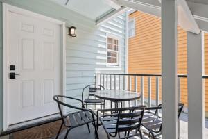 a patio with a table and chairs on a balcony at Freshly Renovated 2 Bedroom Apt Walk Everywhere in Charleston