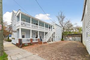 a white house with a porch and a driveway at Downtown 3 Bedroom with Tons of Natural Light in Charleston