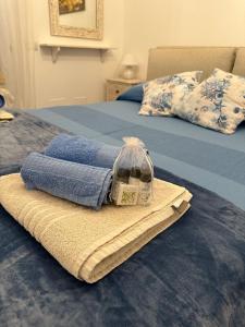 two beds with towels and a bag on them at Aqualife luxury apartment in Arzachena