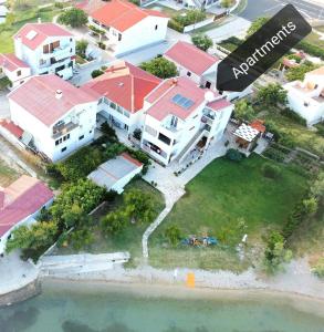 an aerial view of a house on the water at Beachfront apartments Pag in Pag
