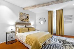 a bedroom with a large bed and a rug at Maison Misericorde in Saint-Tropez